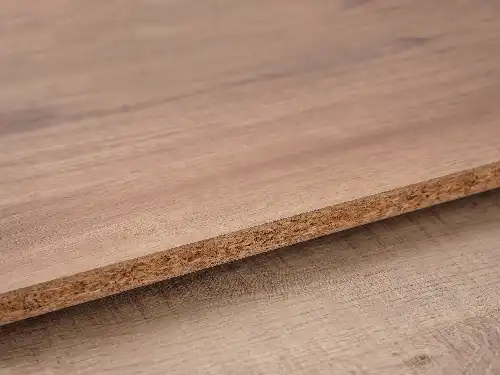 How is melamine particle board laminated?